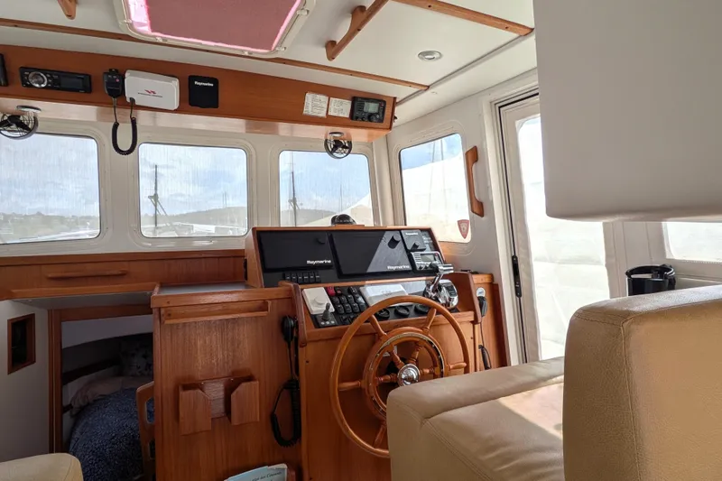 Slide: The Image of Interior of a 2010 Nordic Tug 32 boat with wooden helm and navigation equipment. - 22