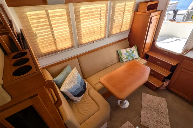 Slide: The Image of Cozy interior of 2010 Nordic Tug 32 with beige seating and wooden table. - 20