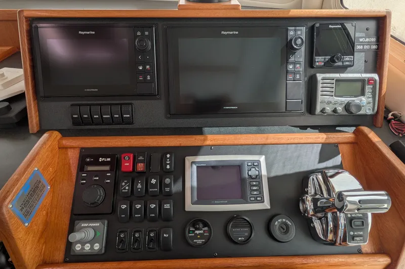 Slide: The Image of Control panel of a 2010 Nordic Tug 32 with navigation and communication equipment. - 27