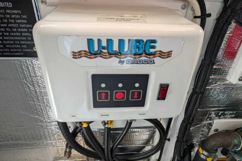 Slide: The Image of U-Lube control panel on a 2010 Nordic Tug 32 boat, featuring buttons and wiring. - 48
