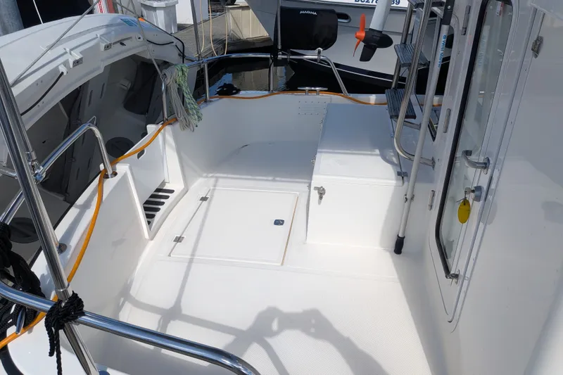 Slide: The Image of Nordic Tug 32 (2010) boat deck with clean white surface and stainless steel railings. - 10