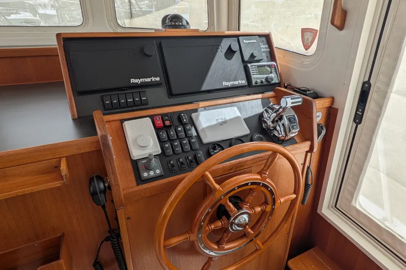 Slide: The Image of Control panel of a 2010 Nordic Tug 32 with Raymarine navigation equipment. - 25