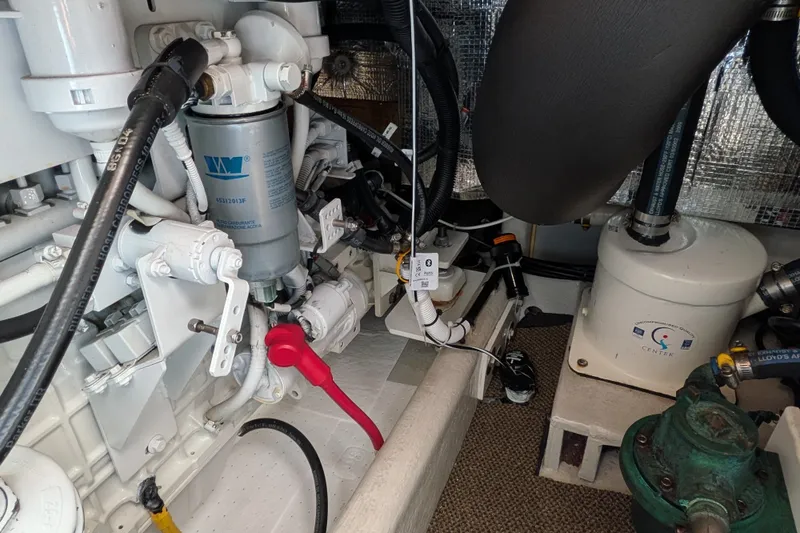 Slide: The Image of Engine room of a 2010 Nordic Tug 32, showcasing mechanical components and systems. - 54