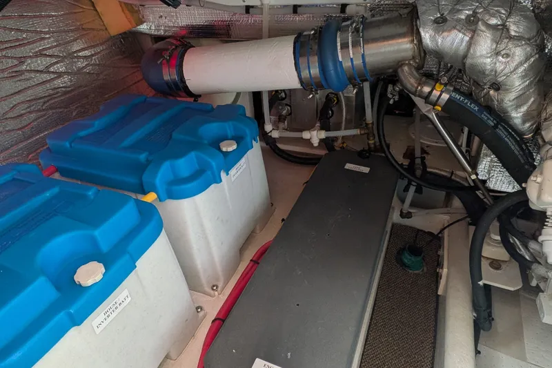 Slide: The Image of Engine room of a 2010 Nordic Tug 32, featuring batteries and insulated piping. - 52