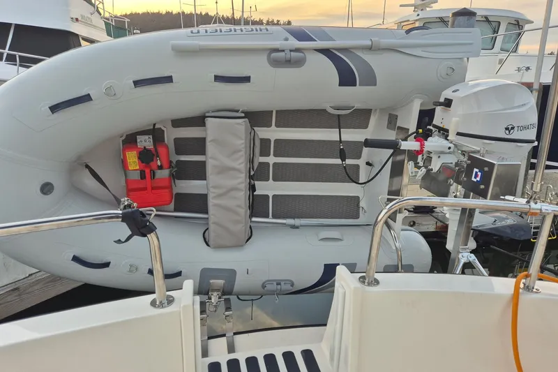 Slide: The Image of Inflatable boat mounted on a 2010 Nordic Tug 32 with Tohatsu outboard motor. - 6