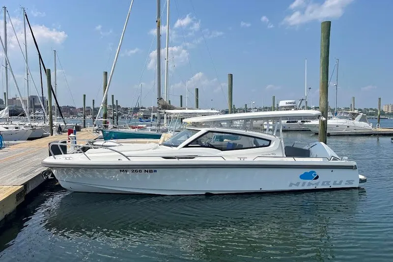 The Image of 2024 Nimbus Weekender 9 boat docked at a marina under a clear blue sky. - 0