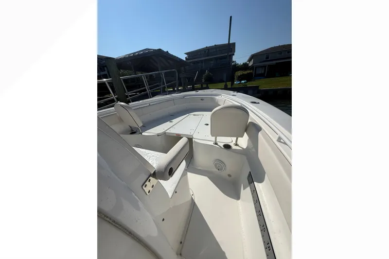 Slide: The Image of 2021 Sea Hunt Gamefish 30FS boat interior with seating and deck view. - 18