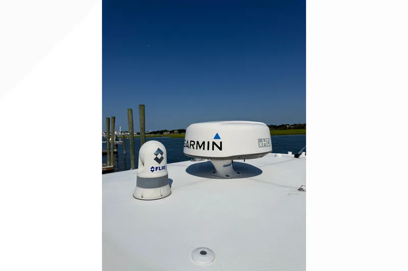 Slide: The Image of Garmin and FLIR equipment on 2021 Sea Hunt Gamefish 30FS boat under clear blue sky. - 12