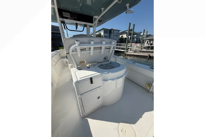Slide: The Image of 2021 Sea Hunt Gamefish 30FS boat interior with fishing rod holders and storage compartments. - 15