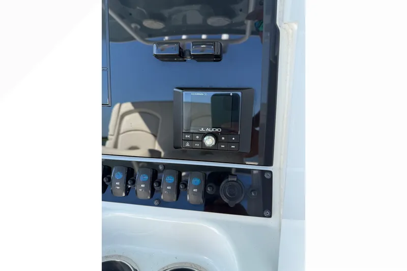 Slide: The Image of Control panel of 2021 Sea Hunt Gamefish 30FS with JL Audio system and switches. - 5