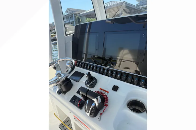 Slide: The Image of Helm of 2021 Sea Hunt Gamefish 30FS with steering wheel and control panel. - 7
