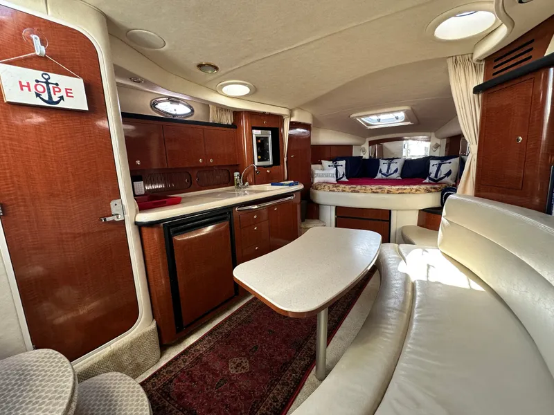 Slide: The Image of Interior of a 2003 Sea Ray 340 Sundancer with elegant furnishings and a cozy bed. - 22