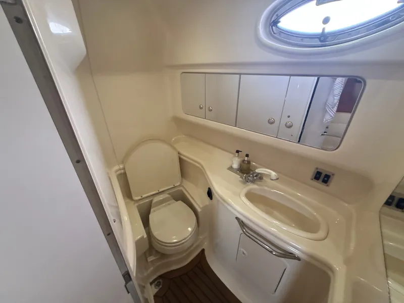 Slide: The Image of Interior view of a boat bathroom with toilet, sink, and mirror. - 25
