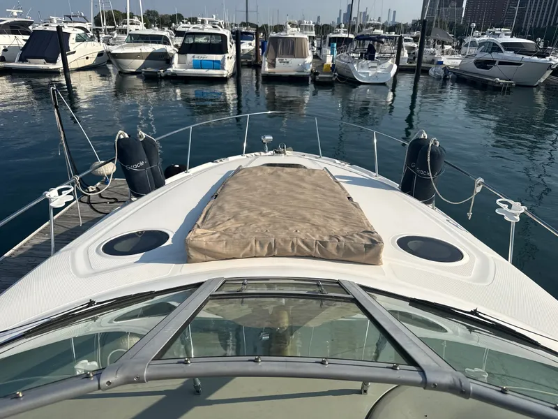 Slide: The Image of A 2003 Sea Ray 340 Sundancer docked in a marina, surrounded by other boats. - 14