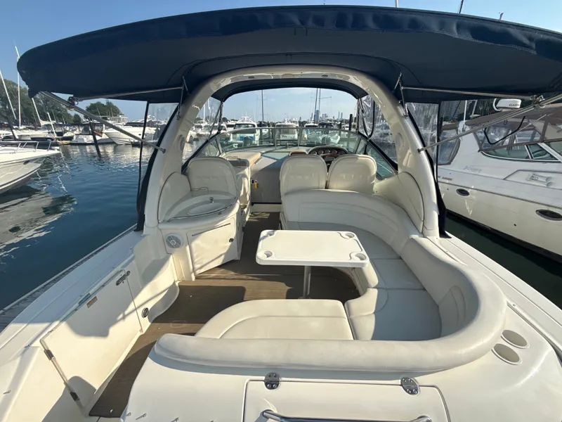 Slide: The Image of The image shows the cockpit of a 2003 Sea Ray 340 Sundancer with beige seating and a table. - 5