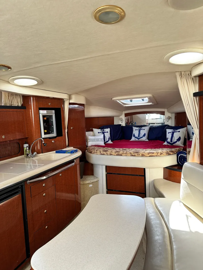 Slide: The Image of Interior of a 2003 Sea Ray 340 Sundancer featuring a kitchen and sleeping area. - 24