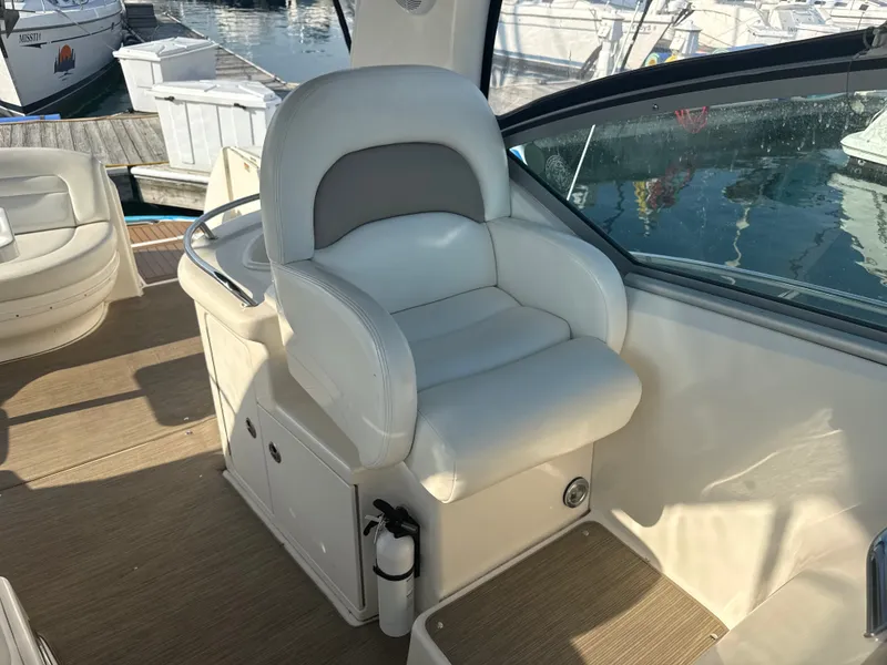 Slide: The Image of The 2003 Sea Ray 340 Sundancer features a sleek white captain's chair in the cockpit area. - 10