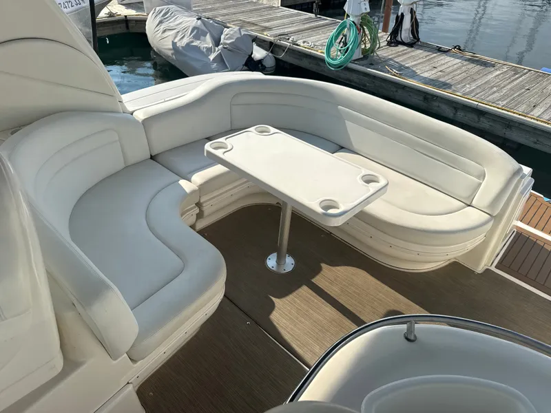 Slide: The Image of The image shows the seating area of a 2003 Sea Ray 340 Sundancer with a table in the center. - 7