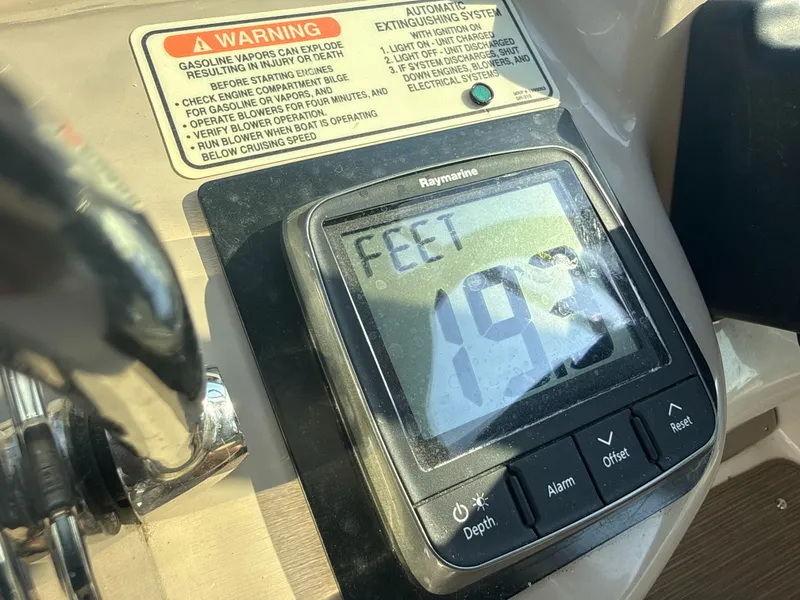 Slide: The Image of A Raymarine depth gauge displays 19.3 feet. A warning label is visible beside it. - 29