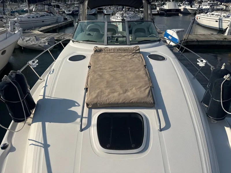 Slide: The Image of The image shows the foredeck of a 2003 Sea Ray 340 Sundancer in a marina. - 15