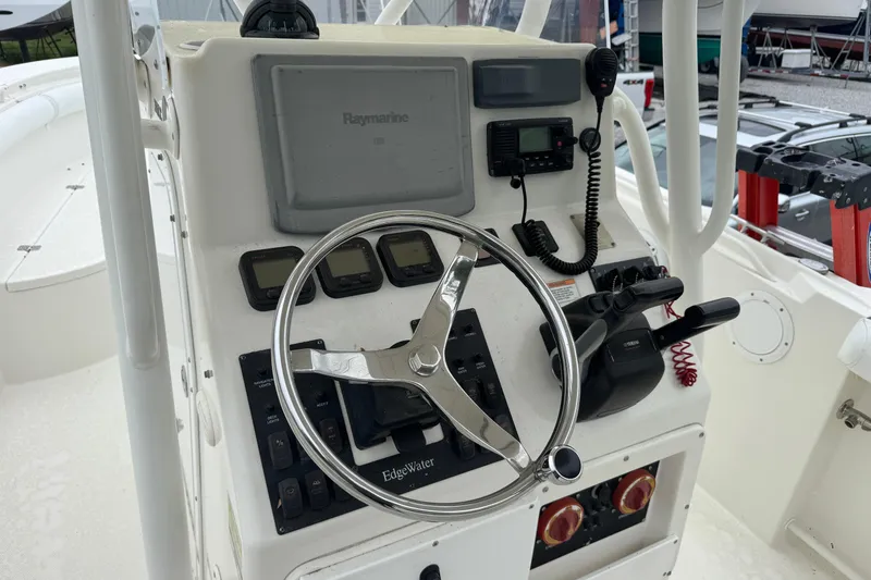 Slide: The Image of Edgewater 245CC 2007 boat console with steering wheel and navigation controls. - 4