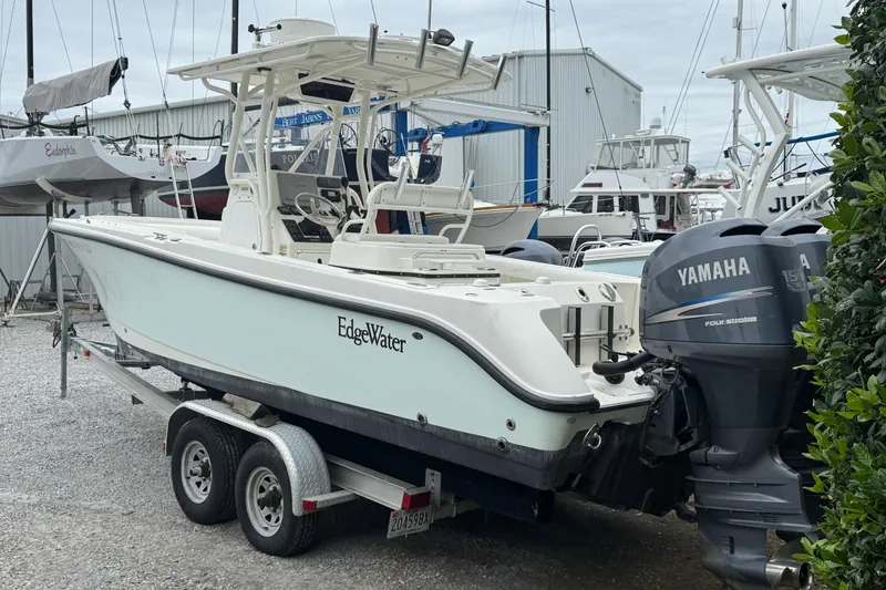 Slide: The Image of 2007 Edgewater 245CC boat on trailer with Yamaha outboard motor in marina setting. - 1