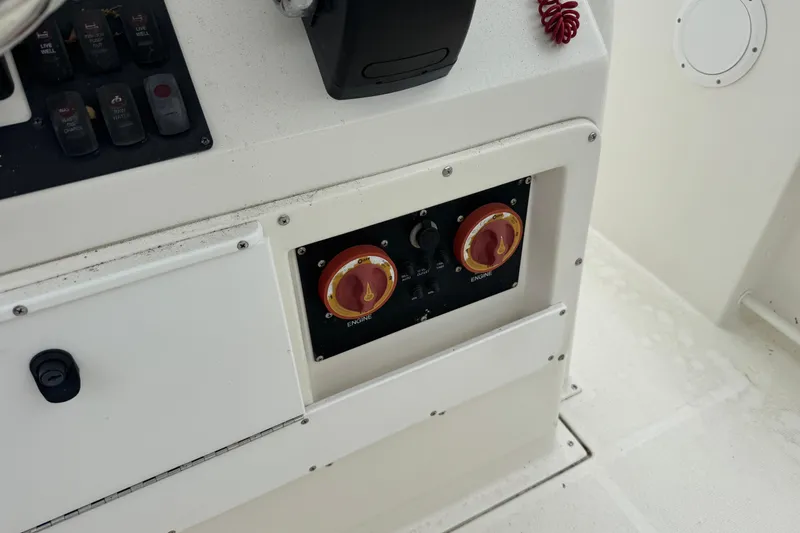 Slide: The Image of Control panel of a 2007 Edgewater 245CC boat with engine switches and controls. - 6