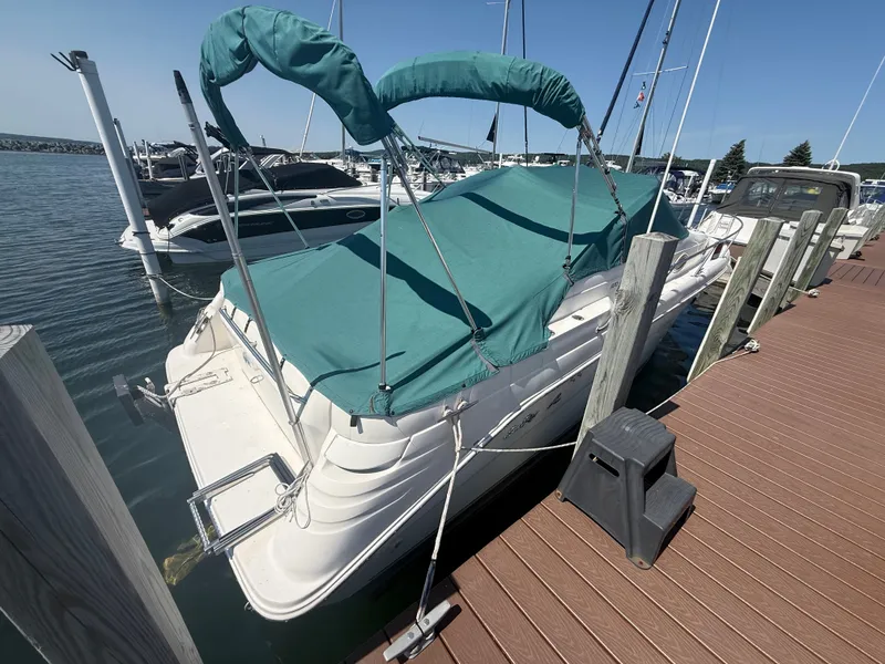 The Image of A 1997 Sea Ray 270 Sundancer docked. It features a green canopy. - 0
