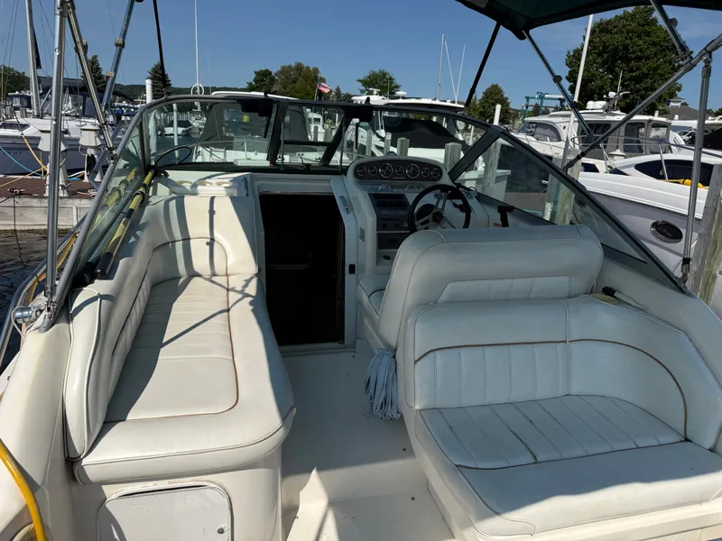 Slide: The Image of The image shows the cockpit of a 1997 Sea Ray 270 Sundancer with white seating and a helm. - 15