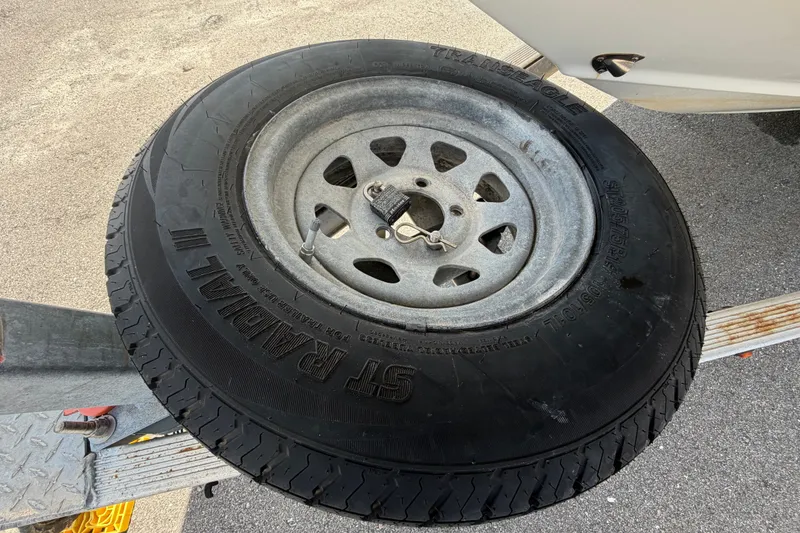 Slide: The Image of Spare tire mounted on a trailer for a 2015 NauticStar 231 Coastal boat. - 79