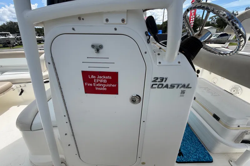 Slide: The Image of 2015 NauticStar 231 Coastal boat interior with safety equipment storage compartment. - 35