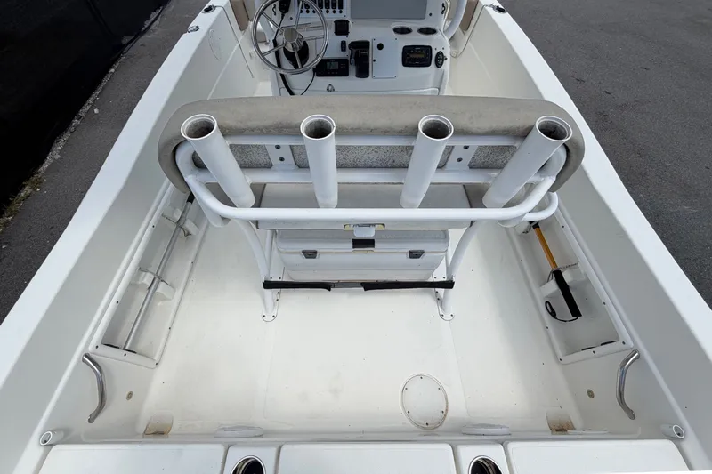 Slide: The Image of 2015 NauticStar 231 Coastal boat interior with rod holders and Garmin navigation system. - 15