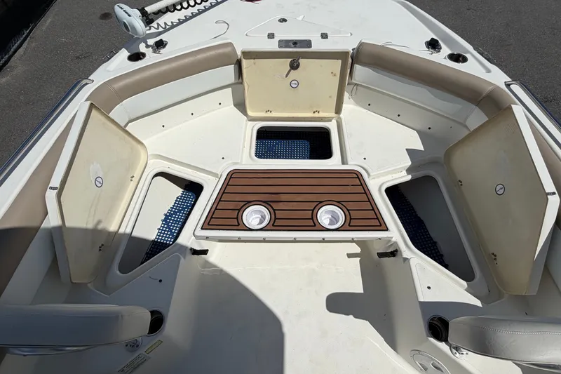 Slide: The Image of 2015 NauticStar 231 Coastal boat interior with open storage compartments and seating. - 42