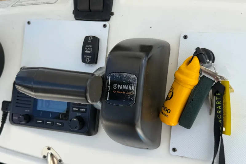 Slide: The Image of Yamaha 704 remote control on 2015 NauticStar 231 Coastal boat dashboard. - 29