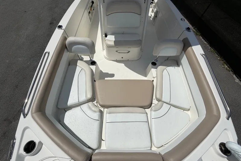 Slide: The Image of 2015 NauticStar 231 Coastal boat interior with cushioned seating and storage compartments. - 51
