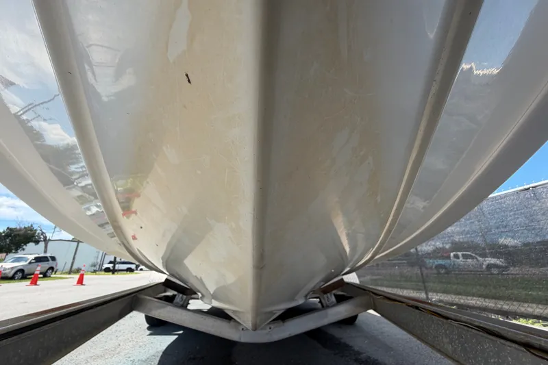 Slide: The Image of 2015 NauticStar 231 Coastal boat hull on trailer, viewed from below. - 11