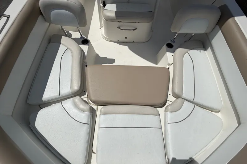 Slide: The Image of Interior seating of 2015 NauticStar 231 Coastal boat, featuring white and beige cushions. - 52