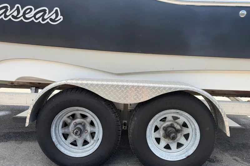 Slide: The Image of Trailer wheels of a 2015 NauticStar 231 Coastal boat. - 77