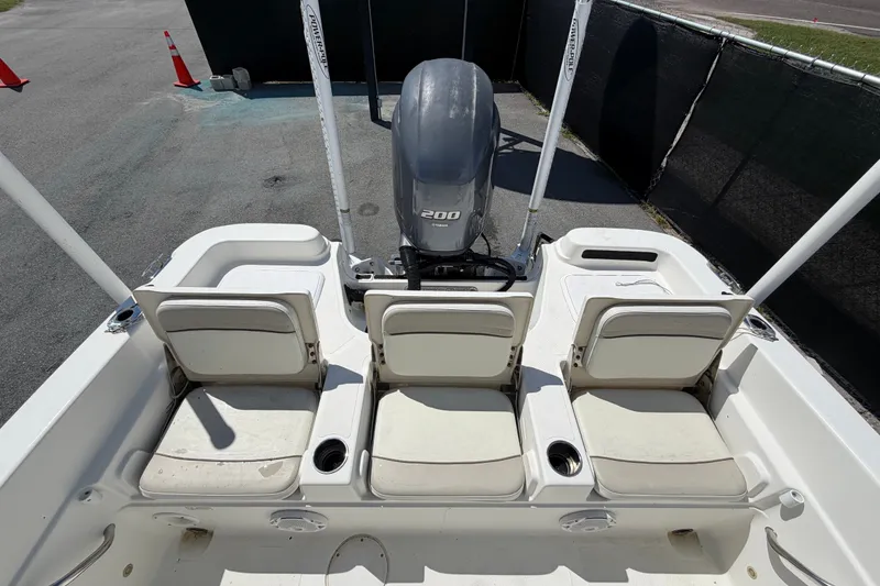 Slide: The Image of 2015 NauticStar 231 Coastal boat interior with seating and outboard motor. - 60