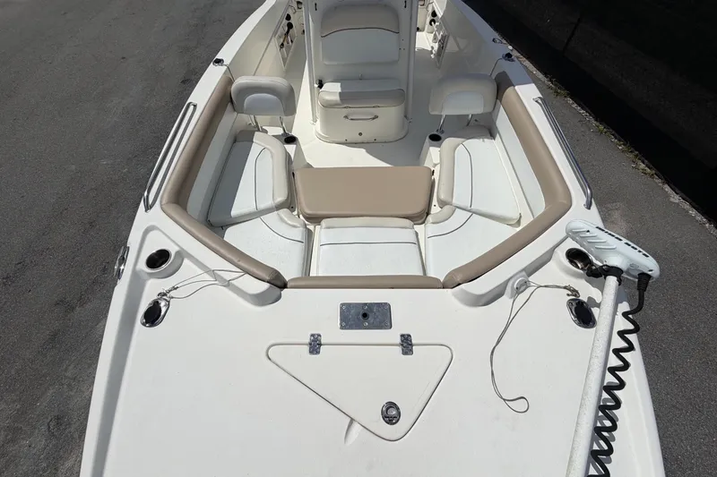 Slide: The Image of 2015 NauticStar 231 Coastal boat interior with seating and storage compartments. - 49