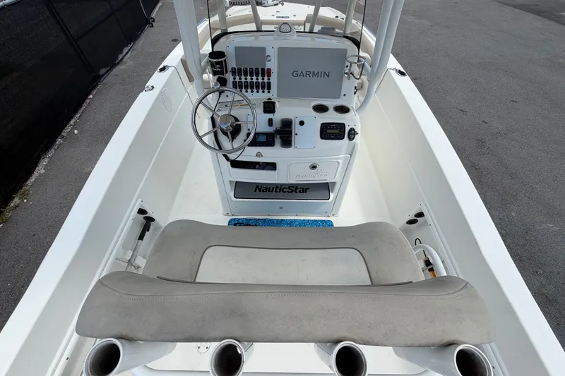 Slide: The Image of 2015 NauticStar 231 Coastal boat interior with Garmin navigation system and steering wheel. - 17