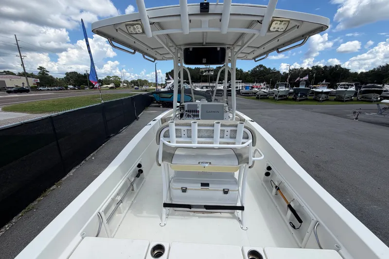 Slide: The Image of 2015 NauticStar 231 Coastal boat interior with seating and navigation equipment. - 12