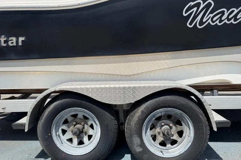 Slide: The Image of Trailer with dual wheels carrying a 2015 NauticStar 231 Coastal boat. - 78