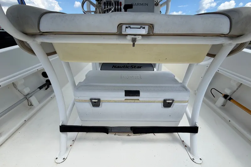 Slide: The Image of 2015 NauticStar 231 Coastal boat interior with cooler and seating. - 16