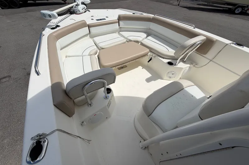 Slide: The Image of 2015 NauticStar 231 Coastal boat interior with beige and white seating. - 39