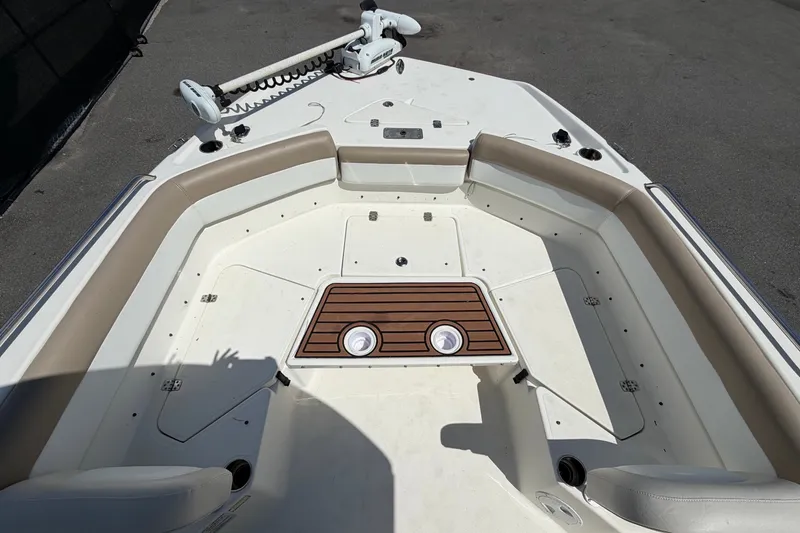 Slide: The Image of The image shows the bow of a 2015 NauticStar 231 Coastal with seating and a wood inlay. - 41