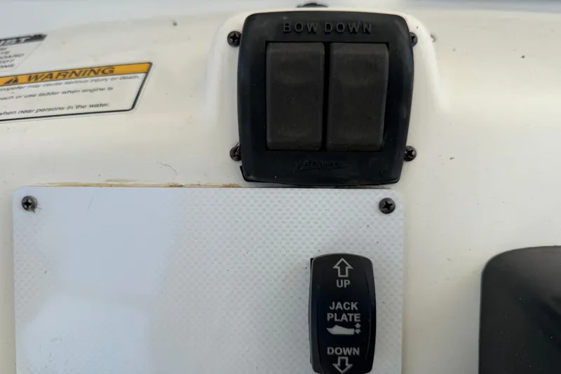 Slide: The Image of Control panel of a 2015 NauticStar 231 Coastal boat with bow and jack plate switches. - 27