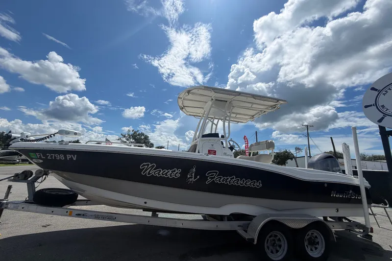 Slide: The Image of 2015 NauticStar 231 Coastal boat on trailer under a partly cloudy sky. - 8