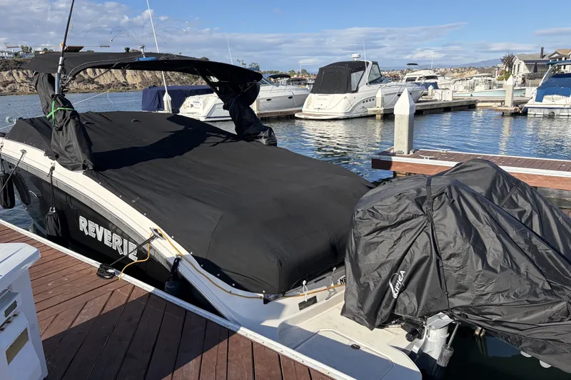 Slide: The Image of 2019 Sea Ray SDX 290 Outboard boat covered at marina dock. - 8