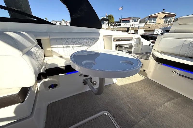 Slide: The Image of 2019 Sea Ray SDX 290 Outboard interior with seating and round table. - 16